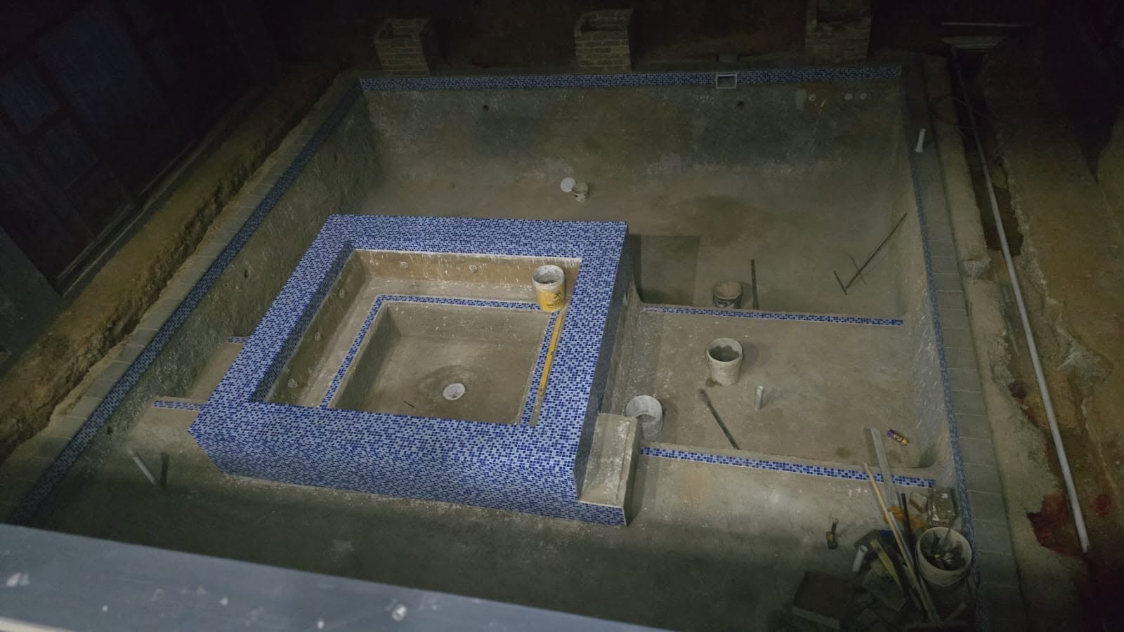 Empty pool shell under construction with blue mosaic tile trim - SGS Pool Specialist Sandringham spa renovation